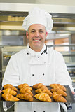Mature baker presenting some croissants