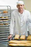 Young male baker standing in a kitchen