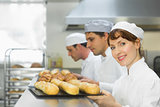 Happy female baker smiling at the camera
