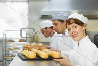 Happy female baker smiling at the camera