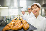 Three young bakers standing in a bakery