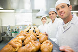 Three young bakers posing in a bakery