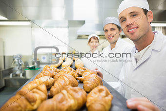 Three young bakers posing in a bakery