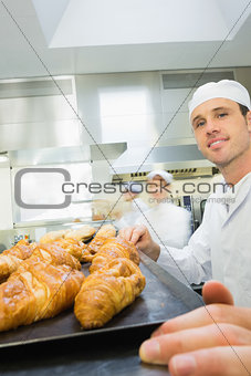 Young male baker standing in a bakery