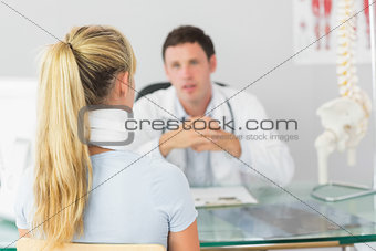 Attractive doctor having an appointment with a patient