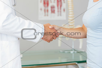 Close up of doctor shaking hands with patient
