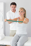 Attractive physiotherapist massaging patient