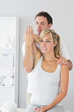 Attractive physiotherapist controlling patients arm