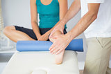 Physiotherapist checking patients leg