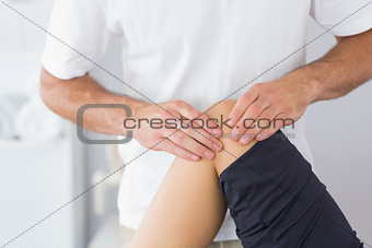 Physiotherapist checking knee of a patient