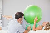 Patient holding exercise ball over chest