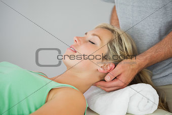 Physiotherapist massaging patients head