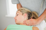 Physiotherapist putting pressure to patients neck