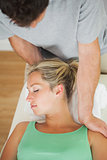 Physiotherapist massaging patients shoulder