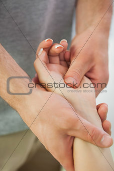 Patients hand being massaged by physiotherapist