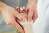 Close up of physiotherapist massaging patients hand