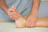 Physiotherapist examining patients foot