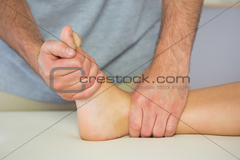Physiotherapist examining patients foot