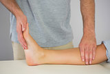 Physiotherapist checking patients foot