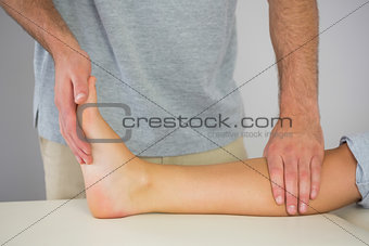 Physiotherapist checking patients foot
