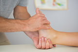 Physiotherapist controlling patients foot