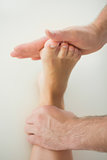 Close up of physiotherapist treating patients foot