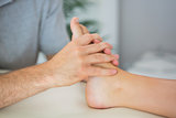Physiotherapist treating patients foot