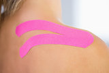Close up of patients shoulder with applied kinesio tape