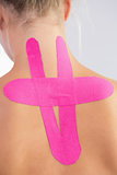 Female patients back with applied kinesio tape