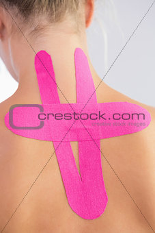 Female patients back with applied kinesio tape