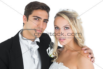 Young bridegroom posing with his wife
