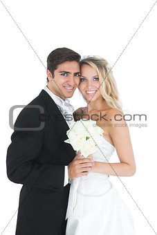 Sweet married couple posing holding a white bouquet