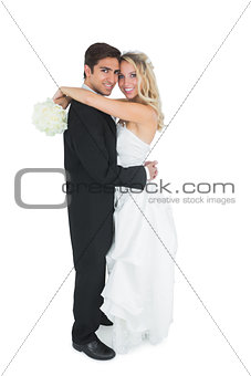 Pretty young bride holding a white bouquet