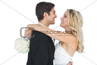 Cheerful pretty bride hugging her husband