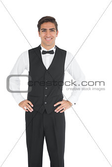 Attractive young waiter posing smiling at camera