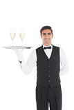 Young waiter presenting a silver tray