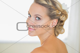 Attractive young bride looking over shoulder