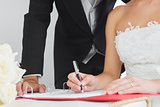Close up of young bride signing wedding contract