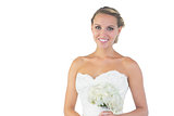 Cheerful beautiful bride posing holding a bouquet