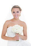 Attractive young bride posing holding a bouquet