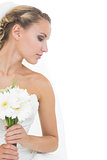Attractive blonde bride holding a bouquet
