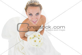 Cheerful blonde bride holding a bouquet