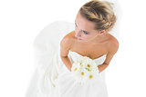 High angle view of blonde bride holding a bouquet