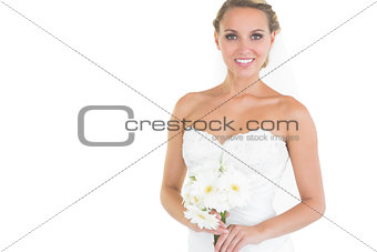 Happy bride posing holding a bouquet