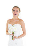Laughing young bride posing and holding a bouquet