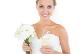 Gorgeous bride holding a bouquet and a champagne glass