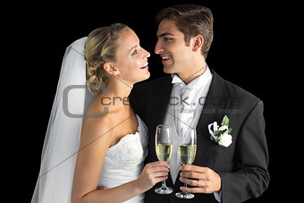 Cheerful married couple holding champagne glasses