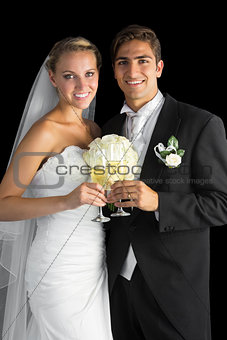Content married couple posing holding champagne glasses