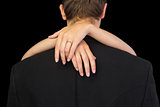 Rear view of brunette man being hugged by his wife