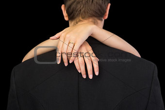 Rear view of brunette man being hugged by his wife
